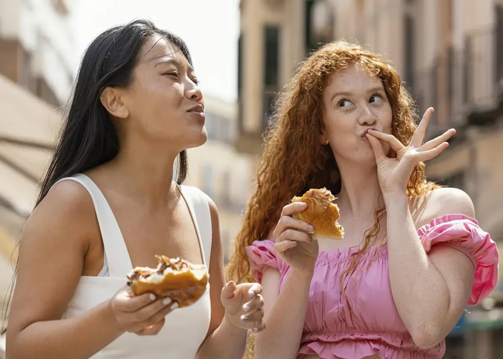 Two girl friends eating in NYC during the summer